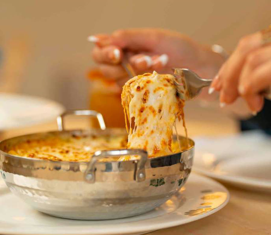 A copper pot of Emirati food being served