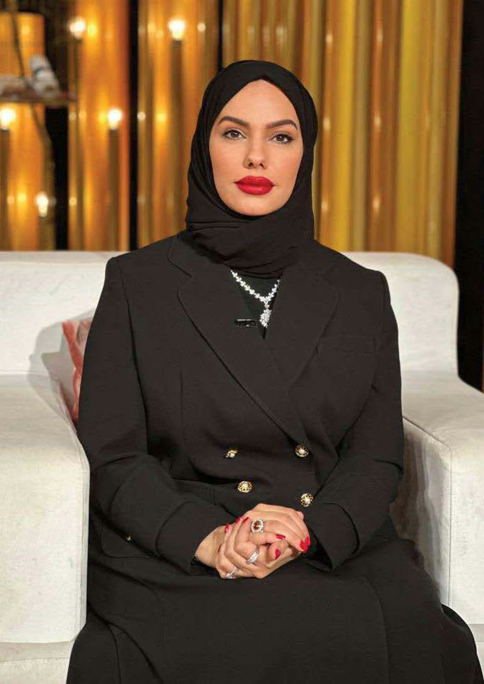 Chef Mariam Almansoori seated, photographed against warm light