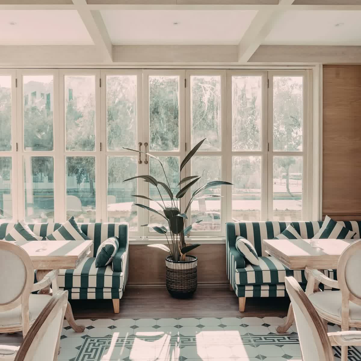 The Montauk dining room with striped seating and tall windows