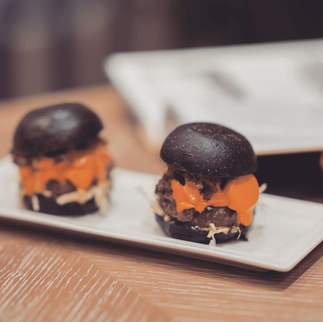 Black bun sliders plated for a Montauk Gala event